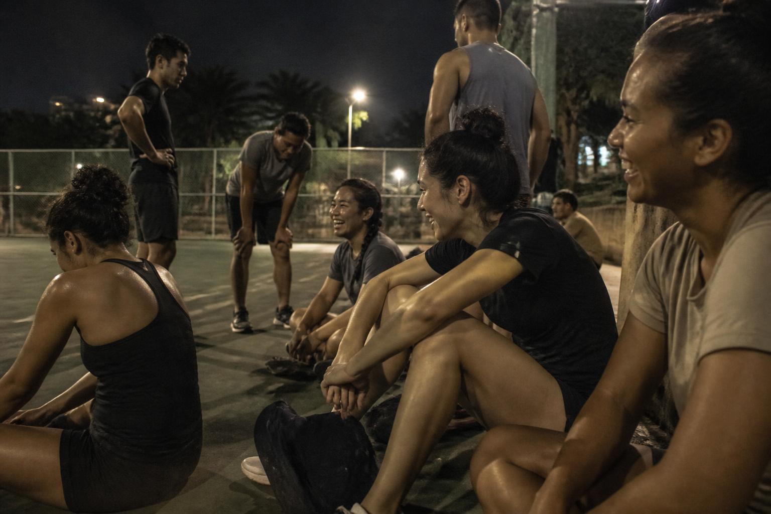 A diverse group of athletes winding down together after a community training night